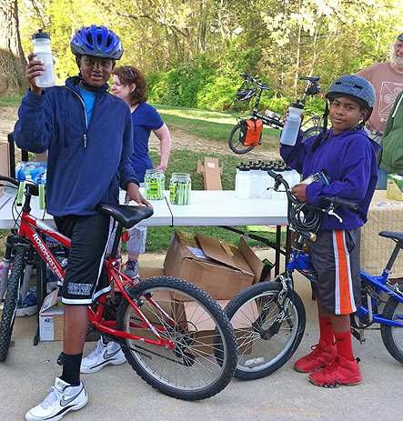 Thomas Harrison Middle School students receive water bottles for participating in Bike to School Day.